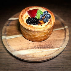 Flaky berry tart with fresh strawberries and blueberries.