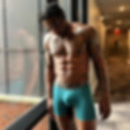 Muscular Patrick Blackwood in Step One boxer briefs in a hallway