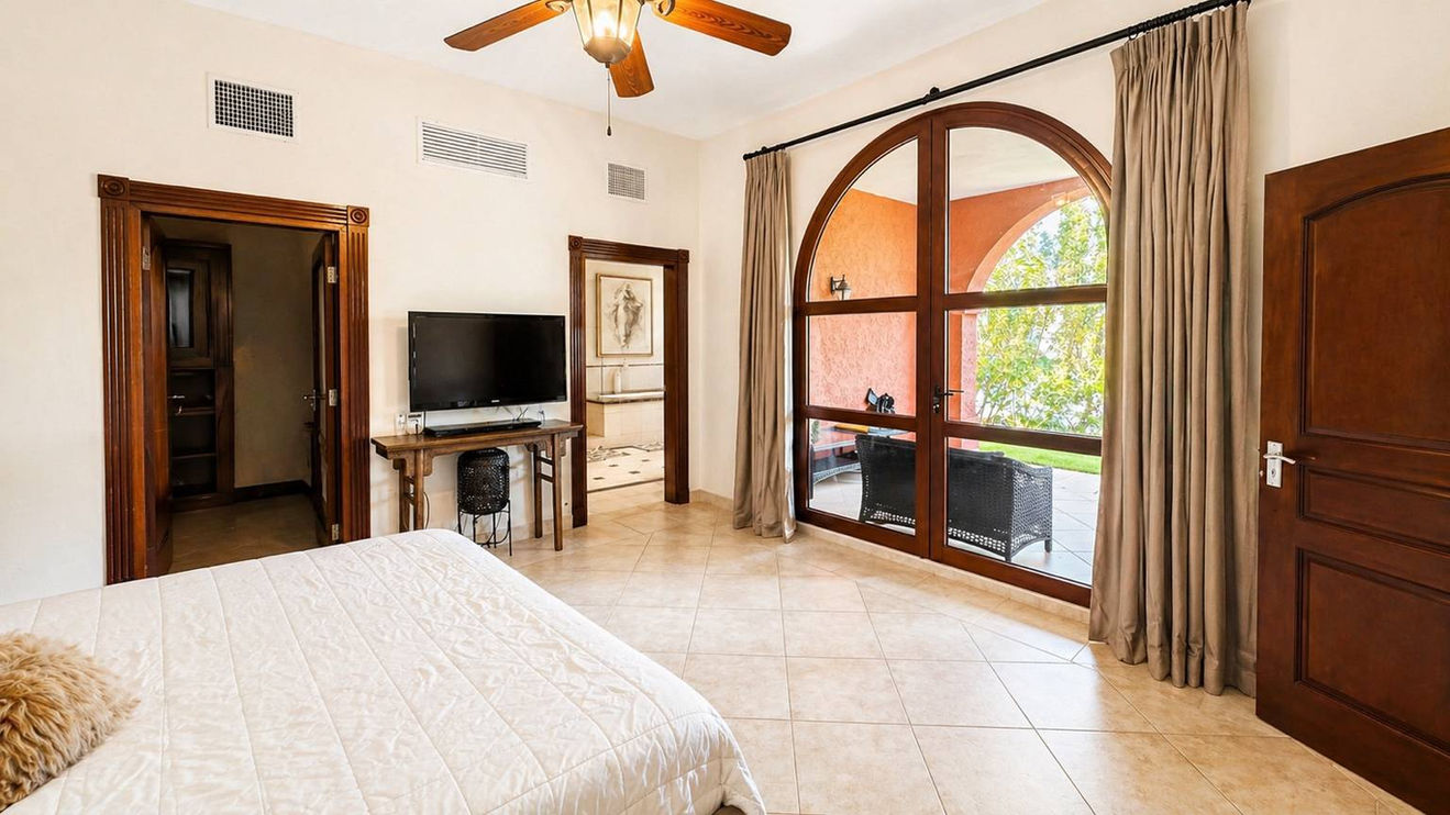 Luxury master bedroom in Sint Maarten real estate with large windows and tropical views