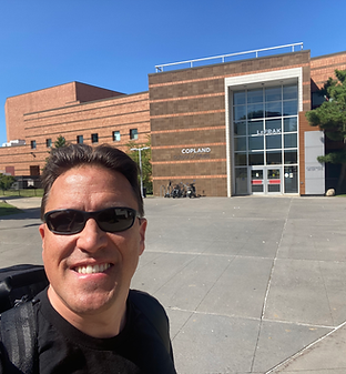 Brad Siroky stands outside the Aaron Copland School of Music at Queens College.