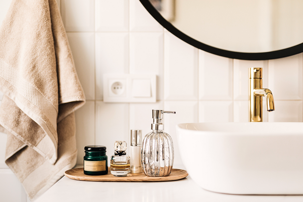 Bathroom vanity with soap, cream, and perfume.