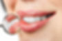 dental mouth mirror near healthy white woman teeth with precious stone on it.jpg