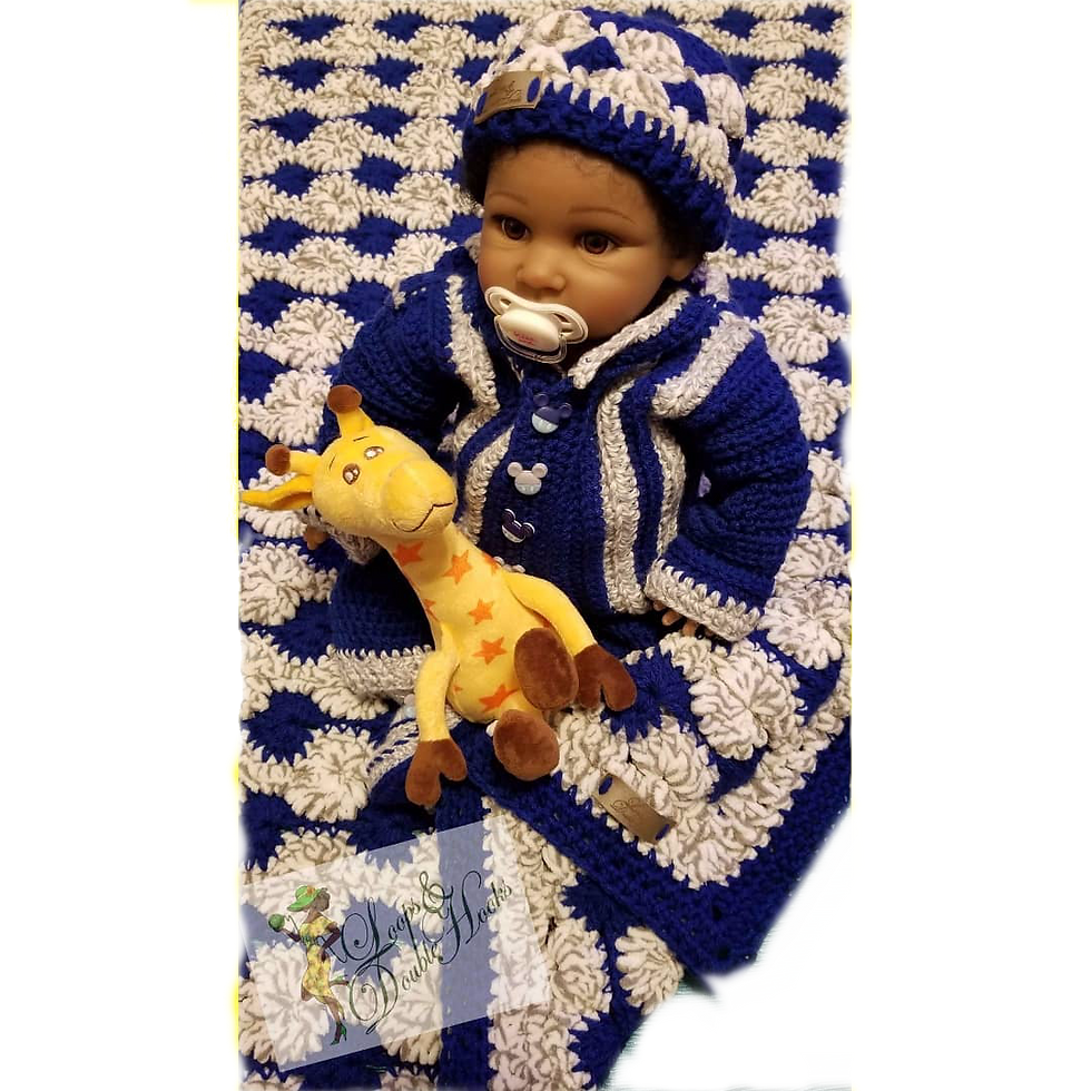 A baby dressed in a blue crochet hat and sweater and wrapped in a crochet blanket that matches the outfit