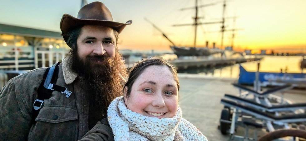 Nathan and Whit smiling in front of the HMS Warrior, at the Hisoric Dockyard, Portsmouth