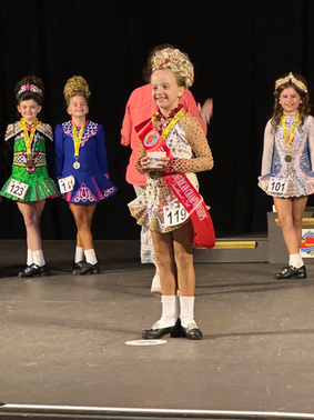 Girl Winning Contest With Competitiors Standing Behind