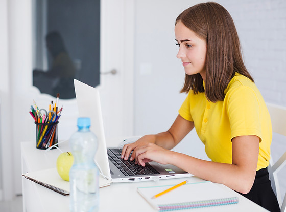 young-girl-typing-on-laptop-at-home.jpg