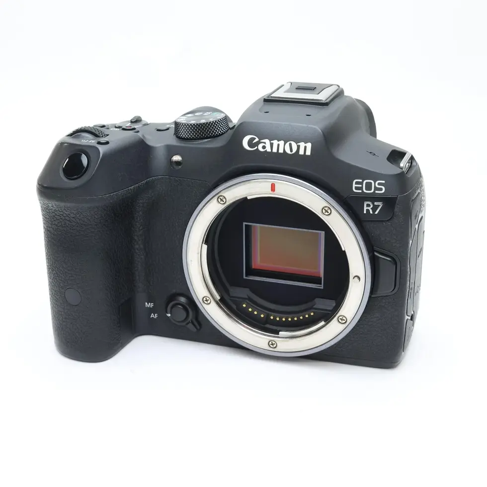 Canon EOS R7 camera body, front view on a white background.