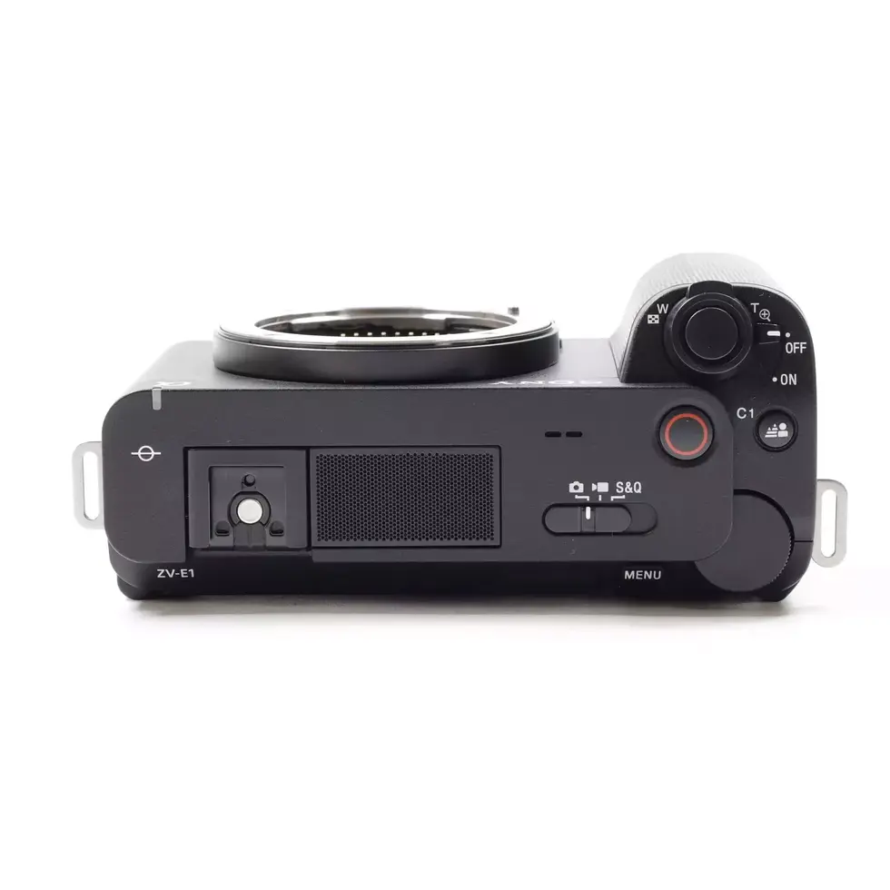 Black digital camera top view, controls and lens detail, photography equipment