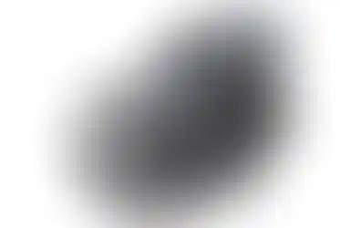 Close-up view of Nikkor Z 70-200mm f/2.8 VR S camera lens against white backdrop.