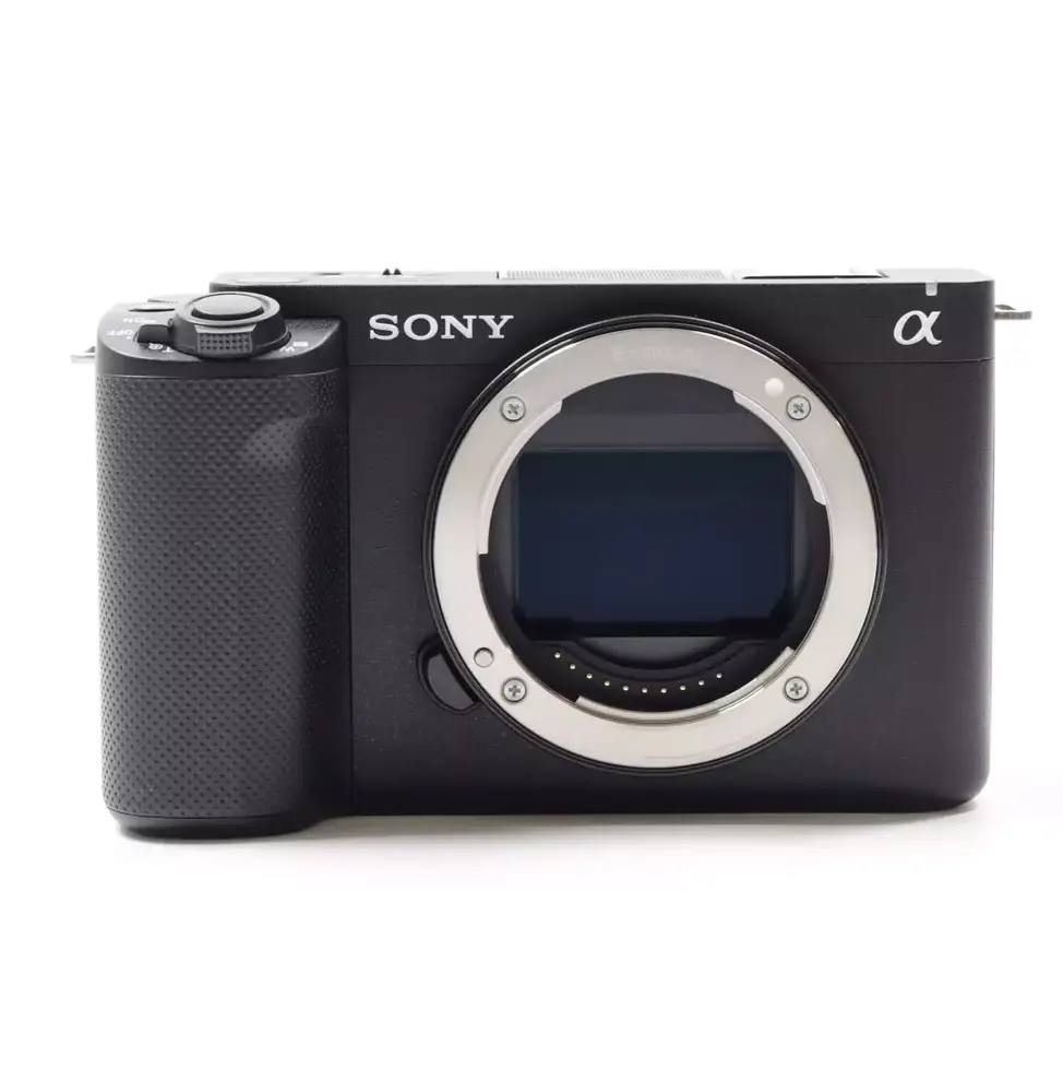 Black Sony camera with lens opening, white background, alpha series photography camera.