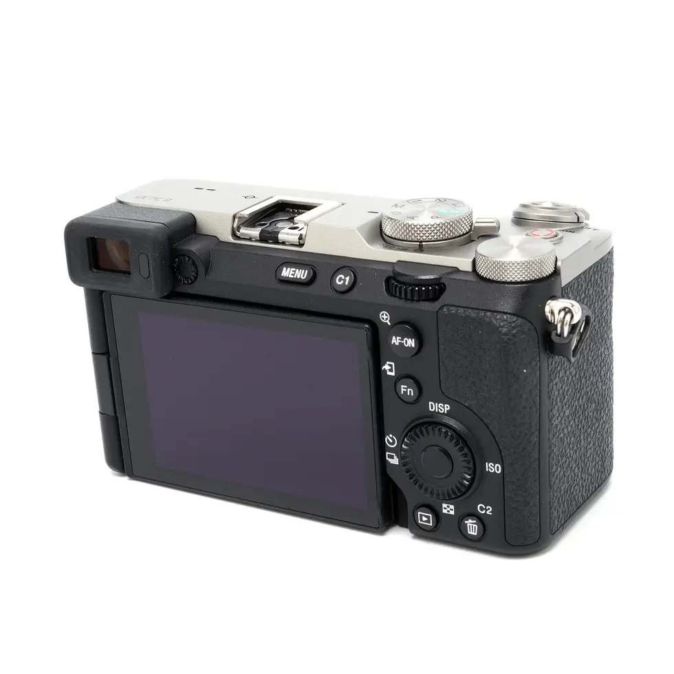 Black digital camera with controls and display screen, isolated on white background.