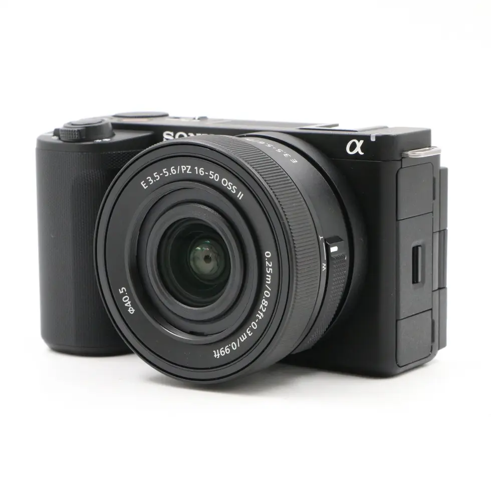 Black camera with lens, Sony Alpha series, isolated view, studio shot Vescar