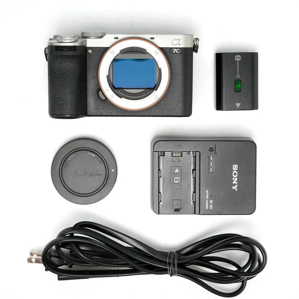Camera and accessories: lens cap, charger, battery, Nikon D5, connection cable