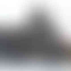 Black Nikon camera with visible logo and open lens against white backdrop