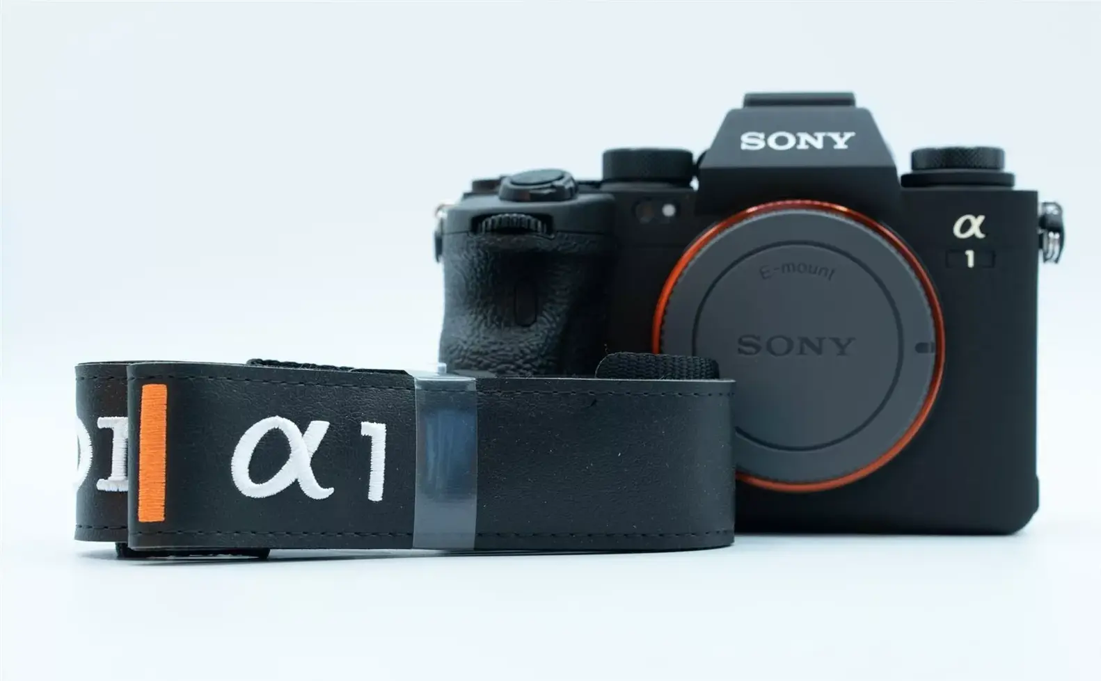 Sony Alpha 1 camera with a battery and a white background.