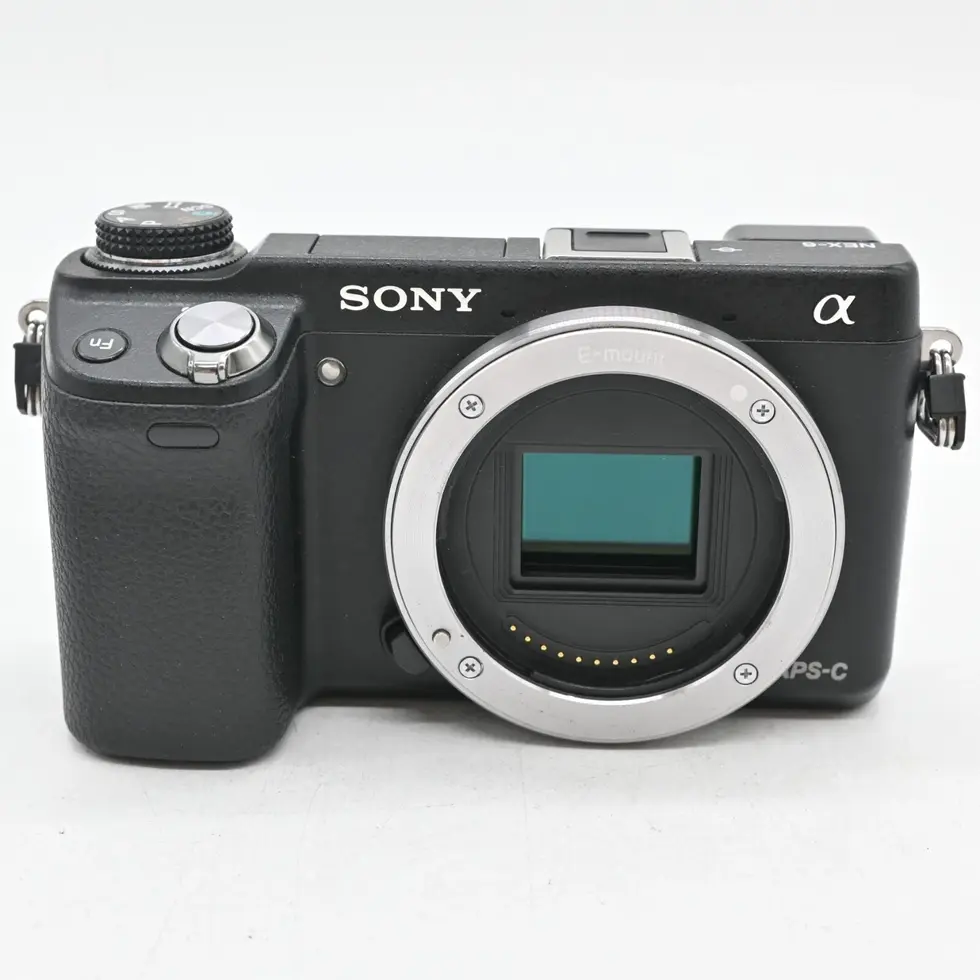Black Sony camera, with the word SONY on the body, and a lens.