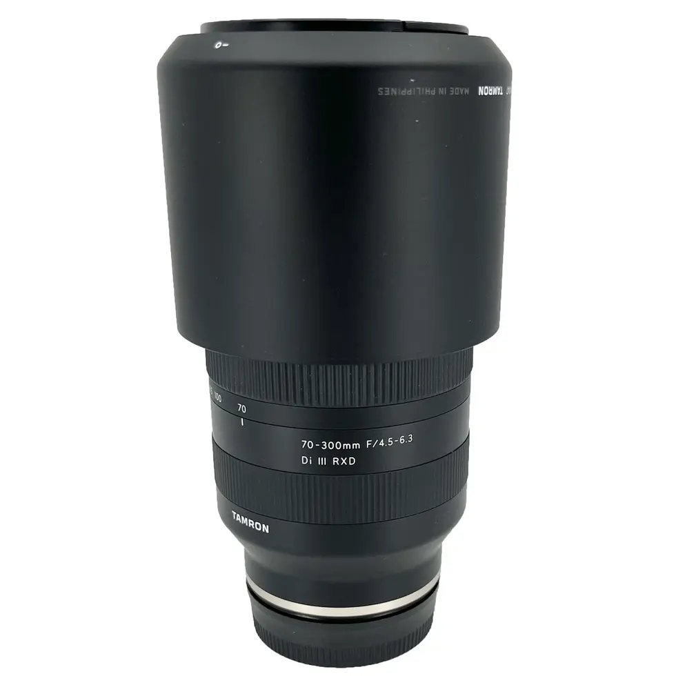 Black Tamron lens with visible text, isolated on white background, Vescar.
