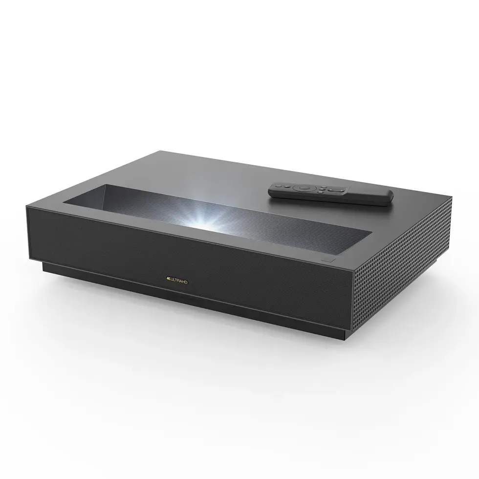 Black projector with remote control, displaying bright light on the surface. Vescar.