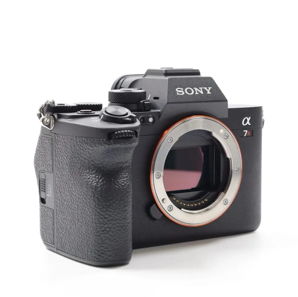 Black Sony digital camera on white background with lens mount