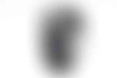 Close-up view of a black digital camera on a white backdrop.