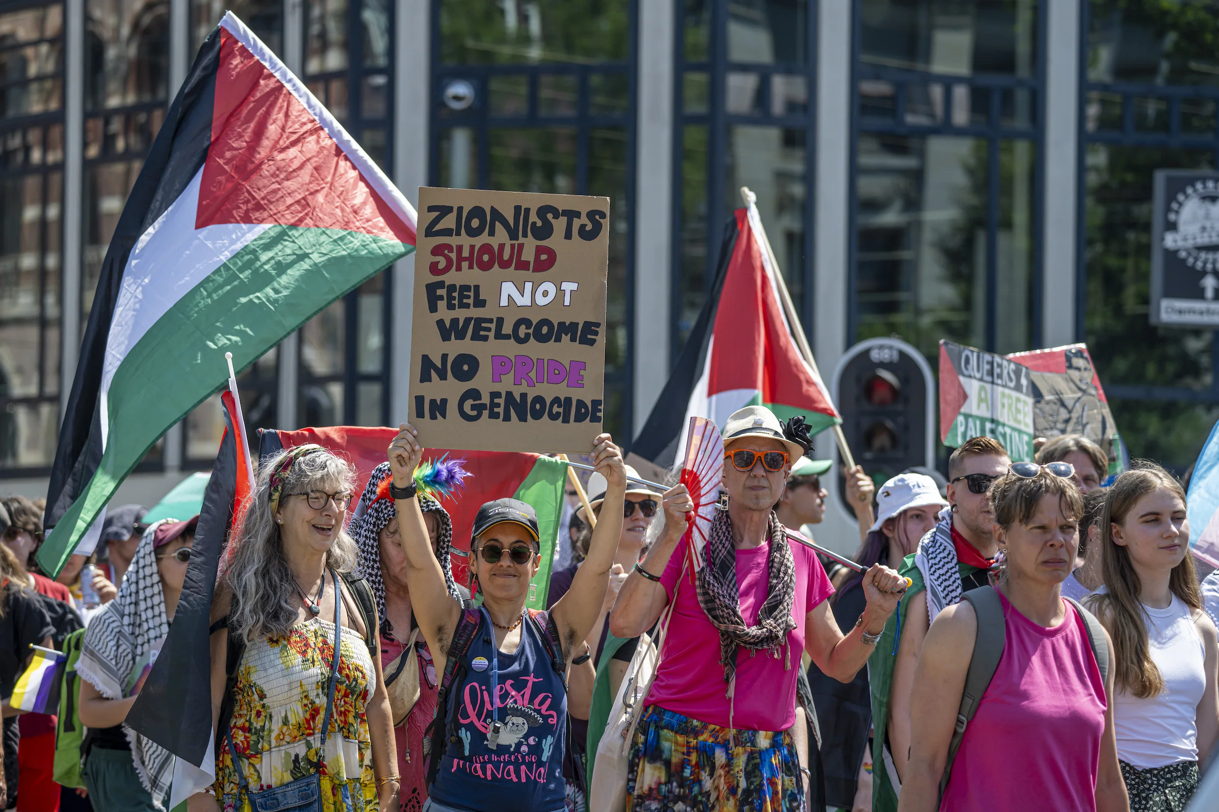 Queer protesters during pride walk in Amsterdam calling for genocide in gaza to stop, and asserting the queer solidarity for palestine