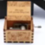 Custom engraved music box. Personalized message inside, plays 'Can't Help Falling in Love.' Unique anniversary keepsake.