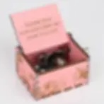 Open pink music box with a personalized "Thank you for teaching me how to love" message under the lid.