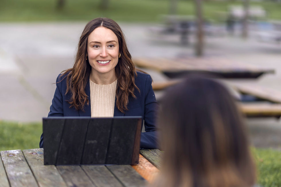 Smiling Jetter professional outdoors with a laptop, symbolizing legal expertise and client dedication.