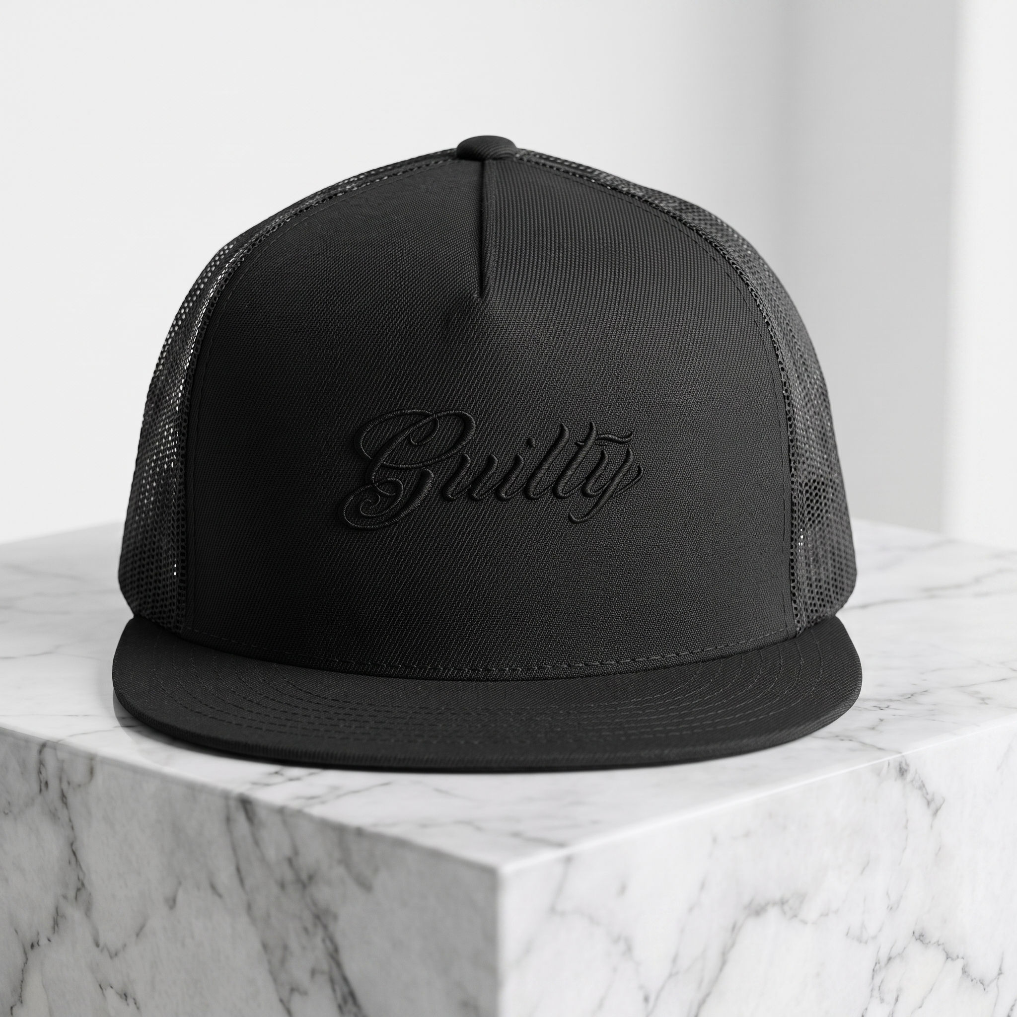 Black GUILTY flat-bill high-profile trucker cap