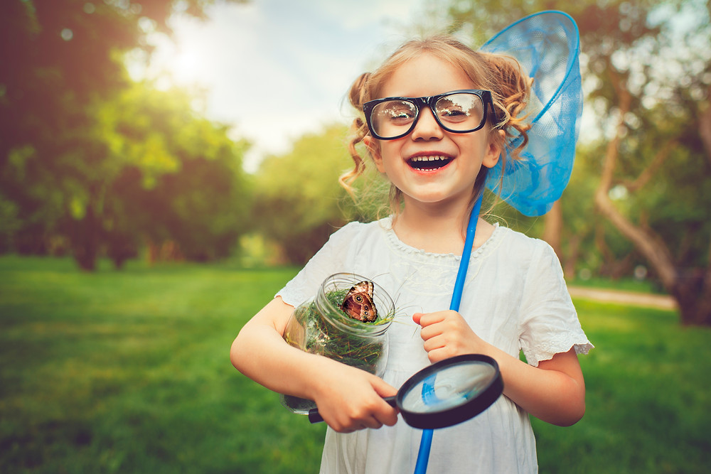 child outside with butterfly green spaces important for children by kozie clothes