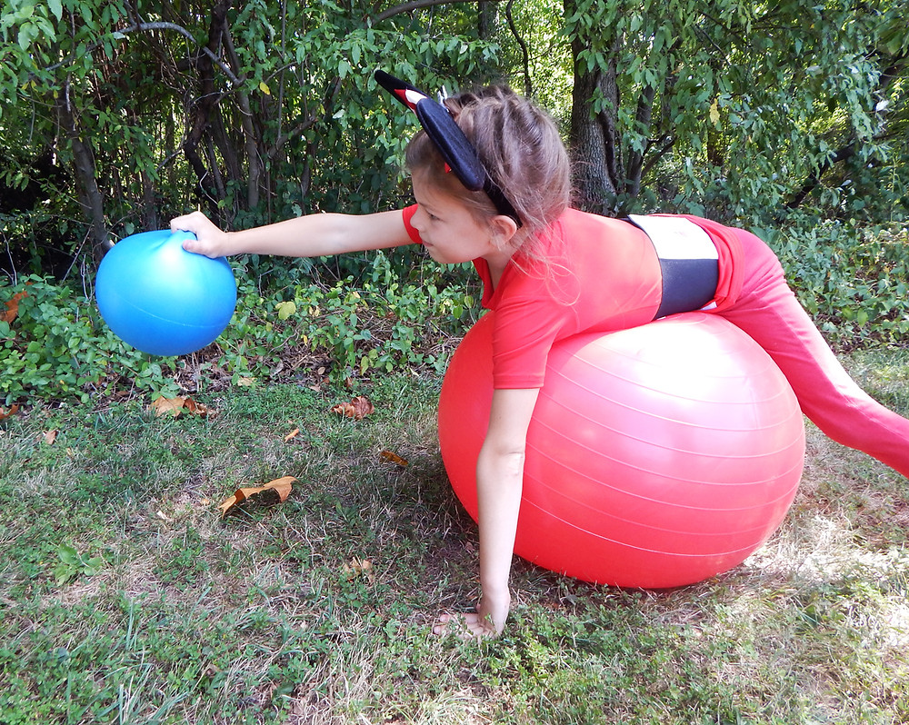 child holding ball ghost bowling activity by kozie clothes