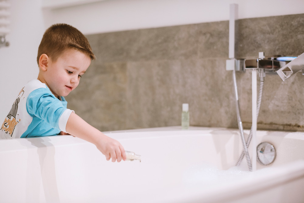 child dropping soap in tub enhance child's sensory experience by kozie clothes