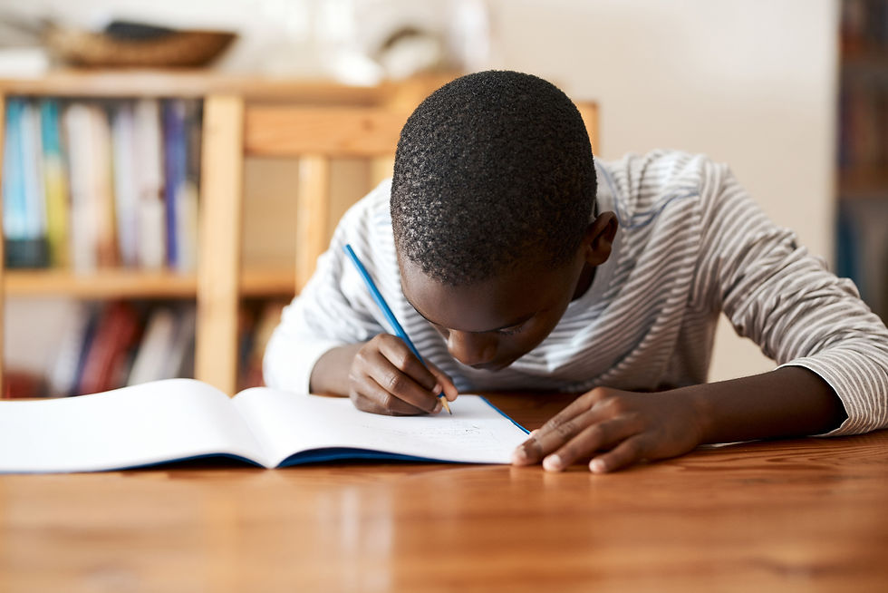 kid writing at table activities for visual sensory system by kozie clothes
