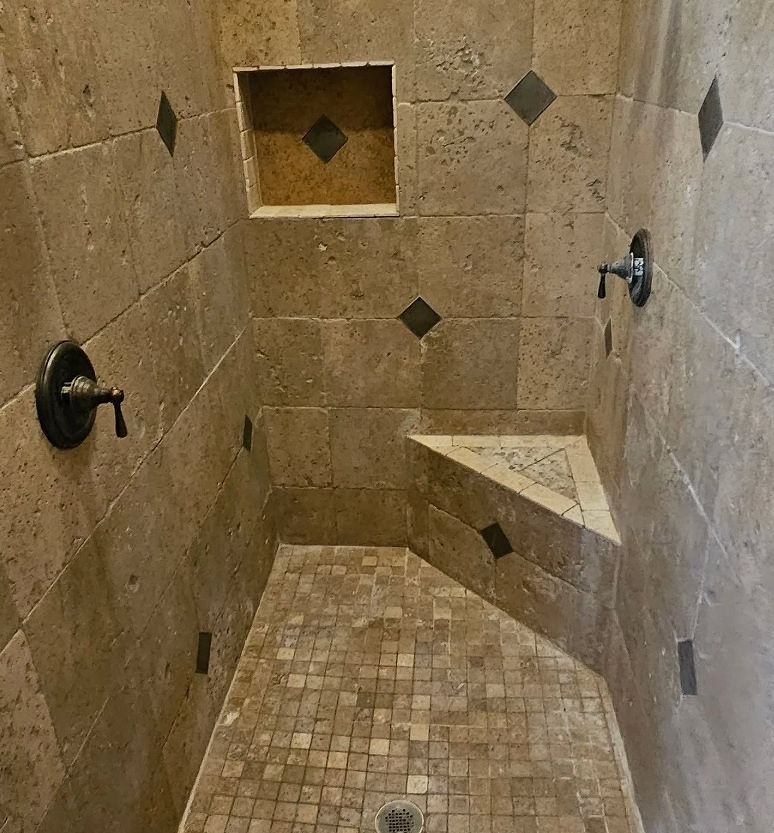 travertine tile shower installation Phoenix AZ with bench and stone tile walls