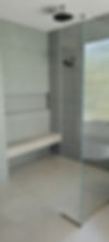 modern walk in shower Phoenix AZ with bench seating and vertical tile walls