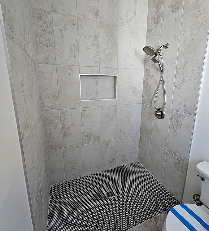 tile shower installation Phoenix AZ with mosaic floor and recessed niche