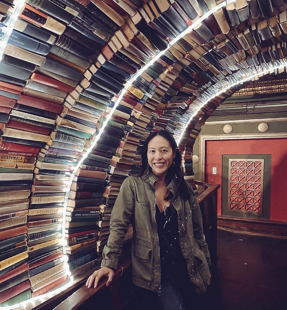 My friend Kat in a cool archway filled with books