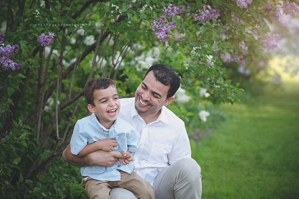 family portrait of Dad and son laughing
