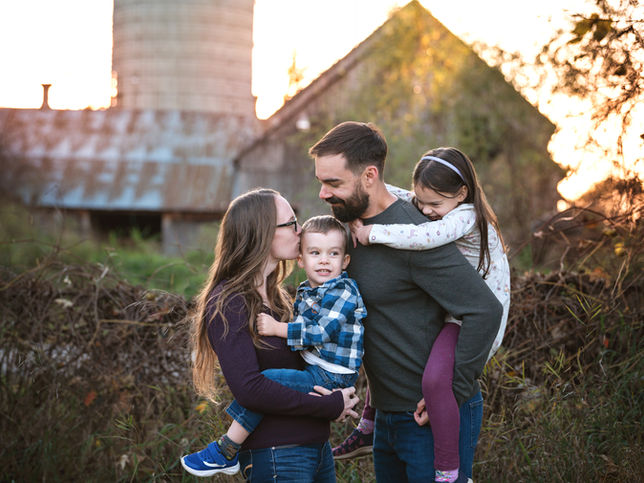 Fall family portrait in front of the setting sun