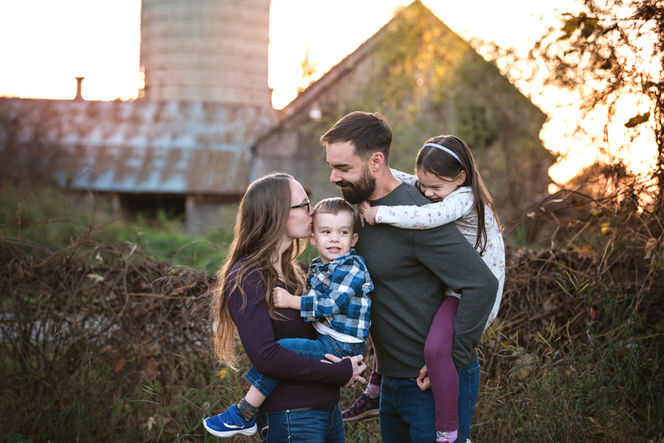 Fall family portrait in front of the setting sun