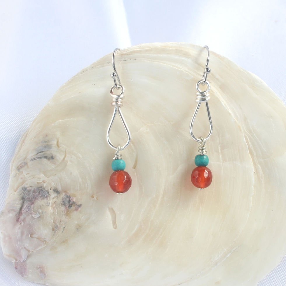 Carnelian Drop Earrings on a shell