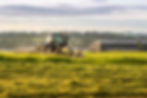 Tractor cutting grass in sustainable agriculture and helping biodiversity net gain.