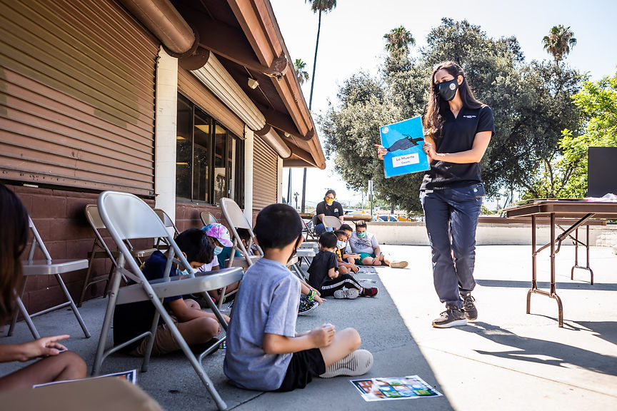 Education Specialist presenting a game card to students.