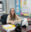 Smiling counselor sitting at desk, Discovery High School