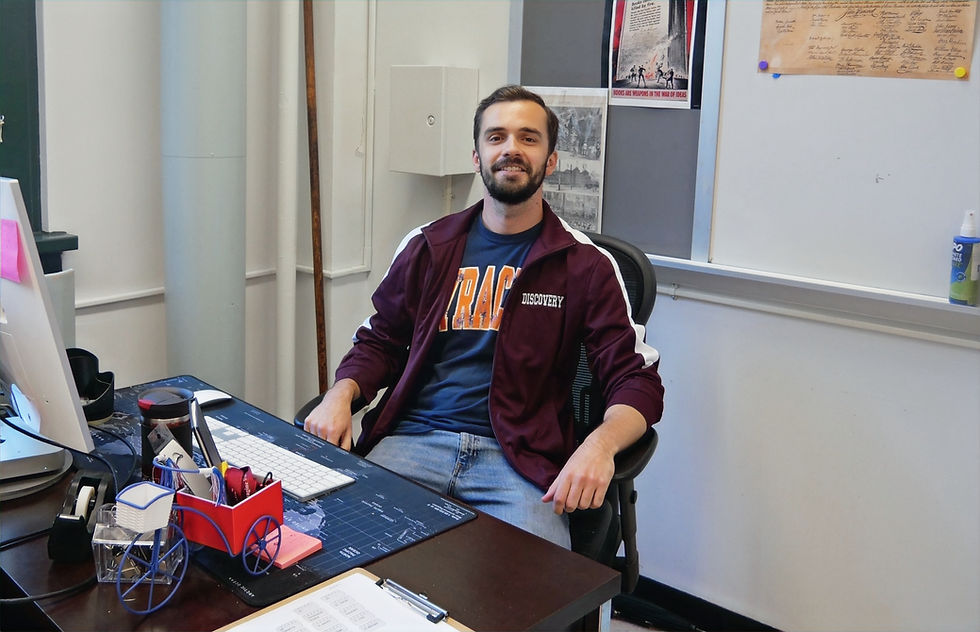 Smiling teacher at desk in classroom