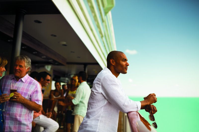 Guest on a cruise ship enjoying the overlooking view