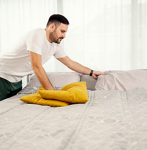 morning-man-making-bed-bedroom.jpg