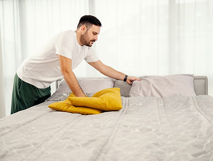 morning-man-making-bed-bedroom.jpg