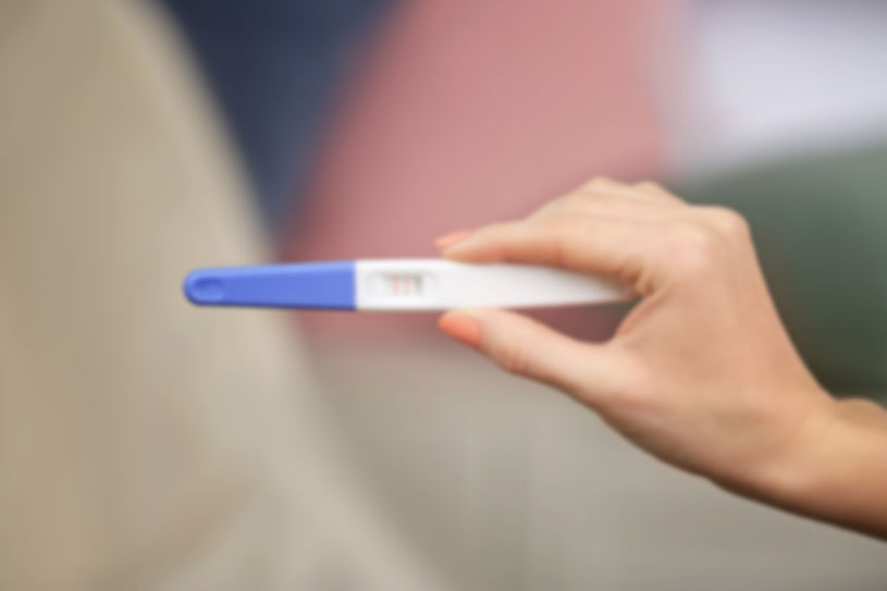 pregnancy-test-hand-blurred-background-living-room blur.jpg