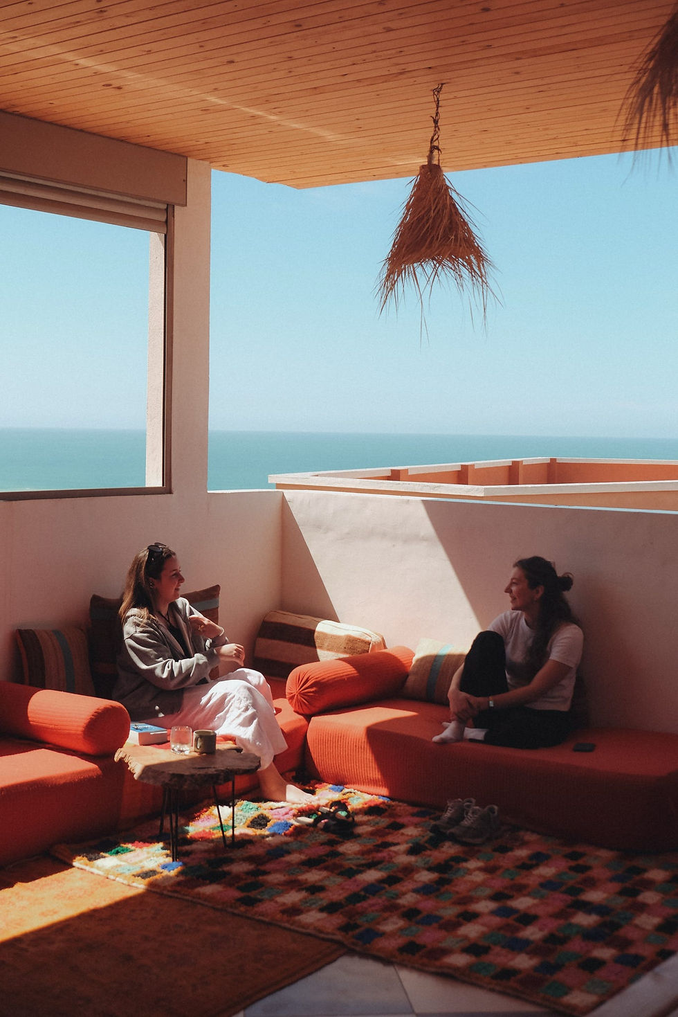 Guests chilling in our surf house terrace lounge